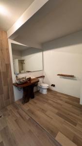 a bathroom with a sink and a toilet in a room at Arena Negraa in Mazunte