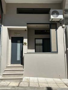 a building with a door and stairs in front of it at ANAVASI Loft SUITE in Alexandroupoli
