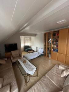 a living room with a couch and a table at Villa-Maru 80qm Ferienwohnung in Lindlar