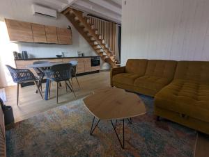 a living room with a couch and a table at Svencele K12 in Svencelė +5 photos