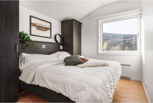 a bedroom with a large bed with a window at Stuga Dundret, Lappland in Gällivare