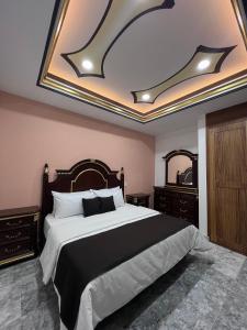 a bedroom with a black and white bed and mirrors at Belova Luxury Hotel, San Cristobal de las Casas in San Cristóbal de Las Casas