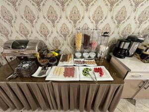 a table with plates of food on top of it at Qamar Hotel in Bukhara