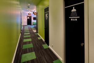 a hallway with green and black floors and a hall at Hostel 365 For U in Dubrovnik