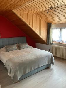 a bedroom with a large bed with a wooden ceiling at Haus am Waldrand in Todtmoos