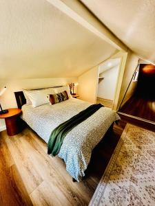 a bedroom with a large bed in an attic at The Falls-Overlooks a waterfall-BBQ-Sleeps 4 in Oakhurst