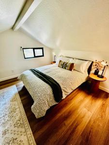 a bedroom with a large bed and a wooden floor at The Falls-Overlooks a waterfall-BBQ-Sleeps 4 in Oakhurst