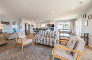a living room with a couch and chairs and a table at Laughing Place - Southern Shores, 175 Ft to Beach, Pool Table, Pets OK, Flex Stays in Southern Shores