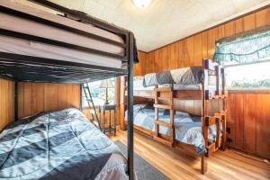a bedroom with two bunk beds and a window at Laughing Place - Southern Shores, 175 Ft to Beach, Pool Table, Pets OK, Flex Stays in Southern Shores