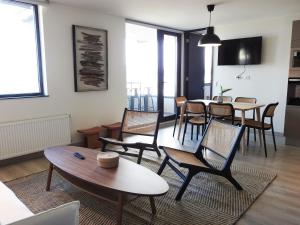 una sala de estar con una mesa y sillas en Departamentos Natales, en Puerto Natales