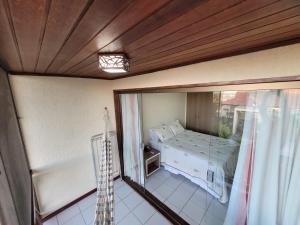 a bedroom with a bed and a glass window at Flat Hotel Fazenda Monte Castelo Gravatá in Gravatá +64 photos