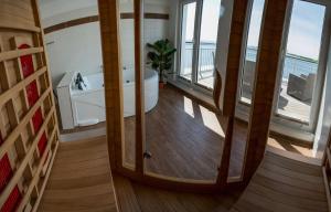 a bathroom with a tub and a view of the ocean at Ferienhaus Wellenreiter in Kappeln +17 photos