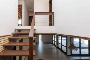 a staircase in a house with a stair case at Casa com piscina até 8 pessoas 10 minutos da Oktoberfest in Blumenau