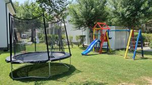 a playground with a slide and a swing set at Villas Corinthia in Baška