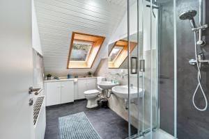 a bathroom with a toilet and a sink and a shower at Zwischen den Wellen in Oldenburg in Holstein +23 photos