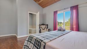 a bedroom with a large bed and a window at Luxury Lake Front Camelot Villa in Pocono Lake +75 photos