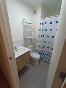 a bathroom with a toilet and a sink and a shower at Departamento en estreno condominio la media central in Lima +12 photos