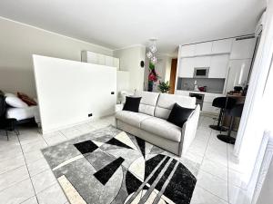 a living room with a couch and a kitchen at LUXURY APARTMENT OPEN SPACE with garden & free parking in Turin +33 photos