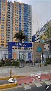 an empty street in front of a building with tall buildings at Departamento en estreno condominio la media central in Lima