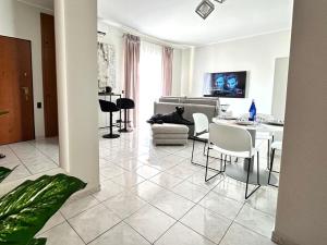 a large living room with a table and chairs at LUXURY APARTMENT OPEN SPACE with garden & free parking in Turin