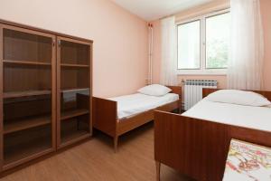 a small room with two beds and a cabinet at Apartment Anne in Crikvenica
