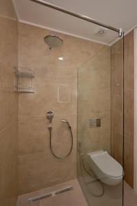 a bathroom with a shower with a toilet at Skyline Sunset in Becici +15 photos