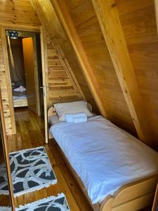 a bed in the attic of a log cabin at Greenland in Žabljak +57 photos
