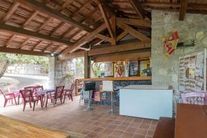 a patio with a table and chairs and a fireplace at Camping Midi - mobil home 6-8 pers in Vallon-Pont-dʼArc