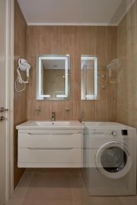 a bathroom with a washing machine and a sink at Skyline Sunset in Becici