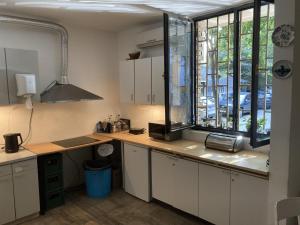 a kitchen with a counter and a window in it at Chillton hostel in Belgrade +56 photos