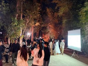 a crowd of people standing in front of a screen at Đầm sen Resort in Hòa Lạc