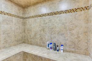 a bathroom with a shower with two bottles of shampoo at Game Room, Home Gym and Deck Littleton Apartment in Littleton +21 photos