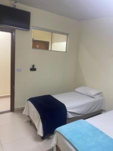 Ένα ή περισσότερα κρεβάτια σε δωμάτιο στο Pousada Centro Oeste +4 φωτογραφίες