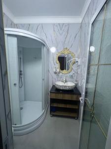 a bathroom with a sink and a mirror at Old town guest house in Bukhara