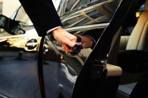 a person is opening the door of a car at Petite Economy Lodge in Skiathos