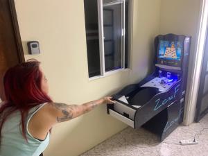 a woman standing in front of a video game console at Lucca Hostel Medellín in Medellín