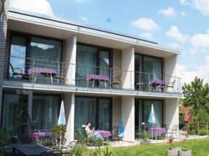 a person sitting on the balcony of a building at Hotel Anker in Bodman-Ludwigshafen