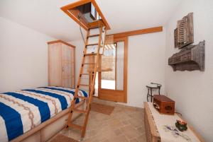 a bedroom with a bunk bed and a ladder at Holiday Home Queen of Kornati in Vrulje