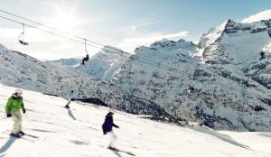 a group of people skiing down a snow covered mountain at Mountaindreams, Wallis, near Saas-Fee, SKi, near Mattmark in Saas-Almagell