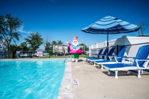 a person is standing next to a swimming pool at Four Corners RV Resort in Antioch +8 photos