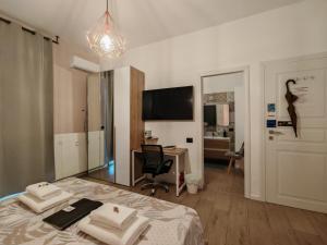 a bedroom with a bed with towels on it at MC FLY ROOMS Malpensa airport in Gallarate