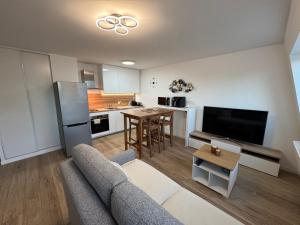 ein Wohnzimmer mit Couch und Küche in der Unterkunft Le charme aux portes de Paris in Bonneuil-sur-Marne + 22 Fotos