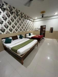 a bedroom with two beds in a room at Shri Mukund Dham - Near Prem Mandir, Iskcon temple & Banke Bihari G- Premanand Maharaj Visit is just 2-3 minutes away in Mathura