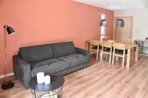 a living room with a couch and a table at Sonnenscheinhaus Wohnung 2 in Erbach im Odenwald +5 photos