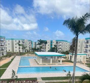 a pool at a resort with people swimming at Cozy Spot Condo in Punta Cana