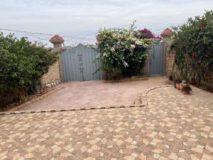 a garden with a gate and a patio at 5 Min to Beach & Calm Villa Retreat in Safi