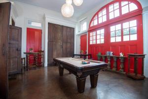 a room with a pool table and red walls at Engine 24 Firehouse Bed & Breakfast in New Orleans