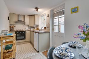 a kitchen and dining room with a table and chairs at 3 Alde Lane in Aldeburgh