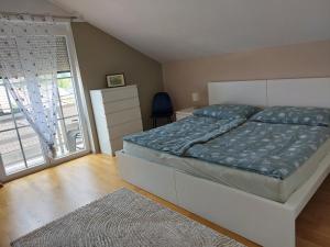 a bedroom with a bed and a large window at Ferienwohnung Gerti in Pinkafeld