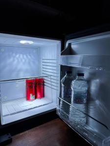 two bottles of water are sitting in an open refrigerator at Suite Romantique, hyper centre in Caen